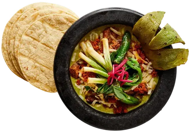 Molcajete Carmelita with grilled steak, chorizo, asadero cheese, roasted serranos and tortillas
